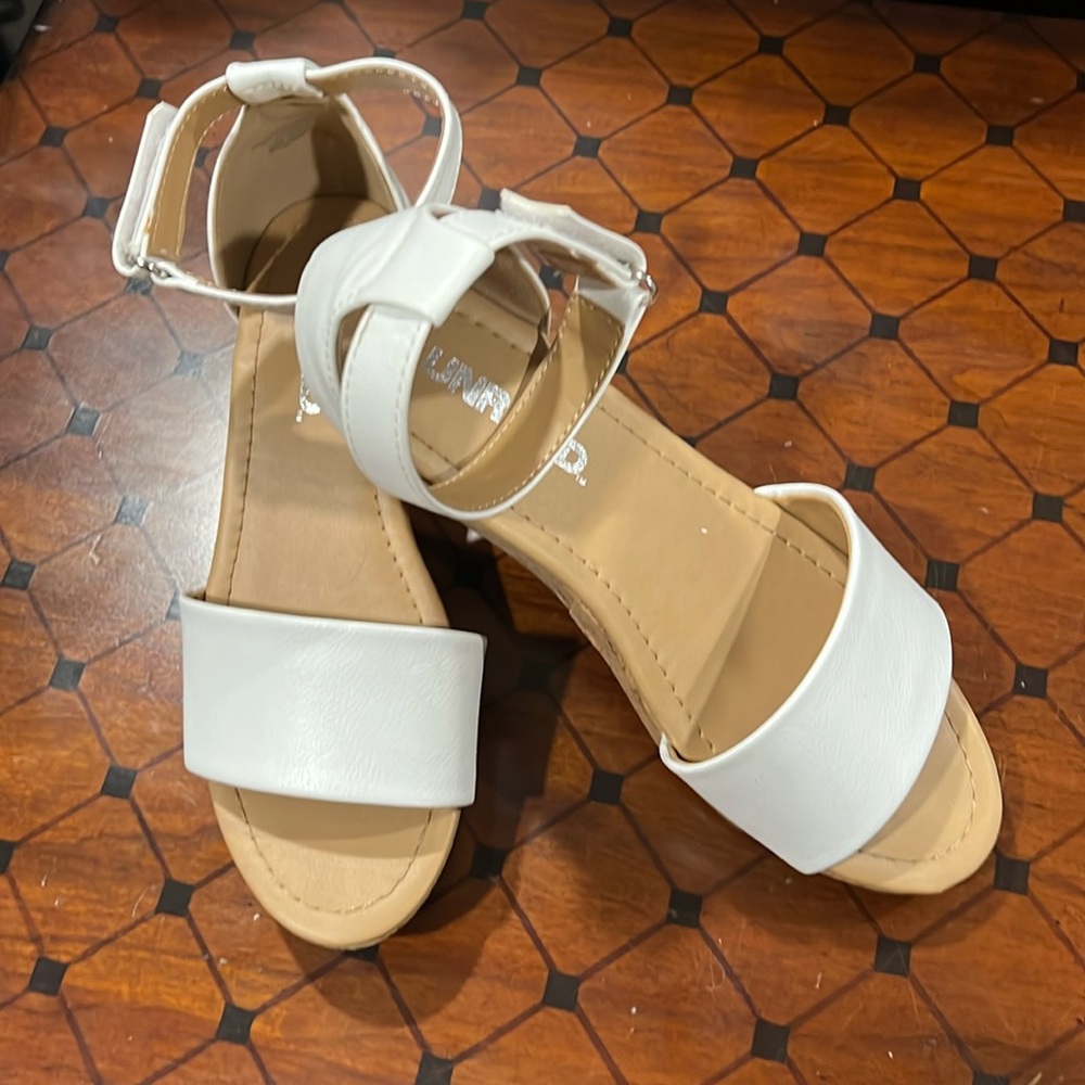 Synthetic white sandle w/ cork wedge heel and adjustable Velcro ankle strap